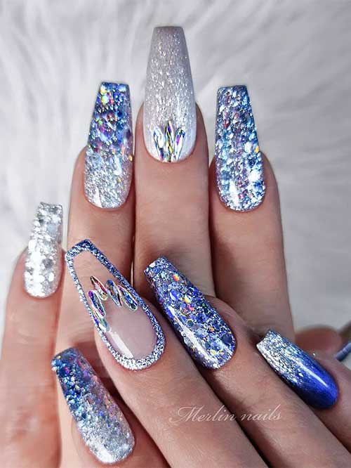 Festive and sparkling glitter blue and silver long coffin nails that suit New Year's Eve celebration