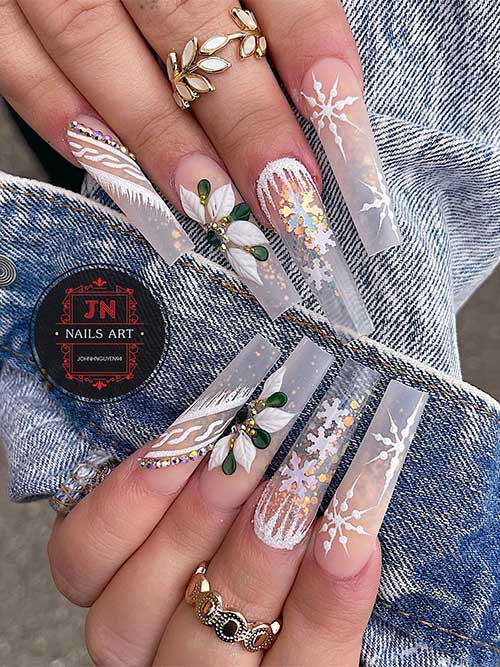 Long coffin clear winter nails feature encapsulated gold glitter, glitter snowflakes, icicles, and sweater nail art