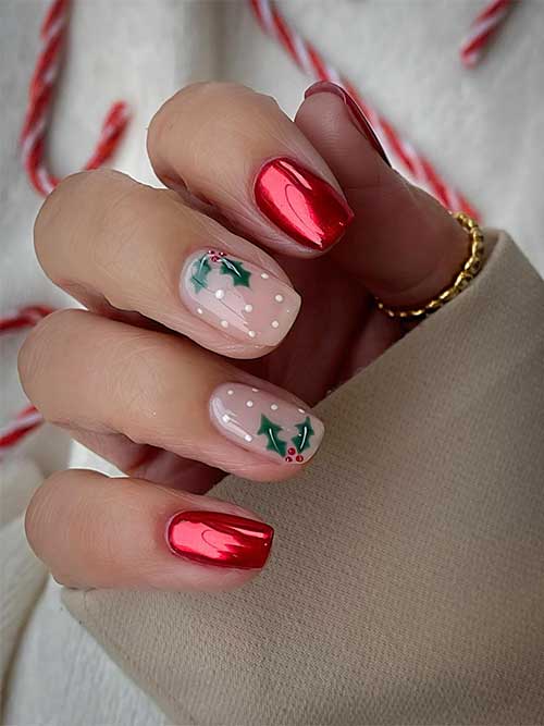 Short red chrome festive Christmas nails with two accent nude nails adorned with holly nail art and white dots