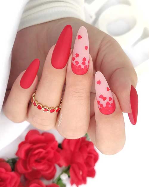 Gorgeous matte red Valentine’s nails with two accent nude pink nails adorned with red fallen heart nail art