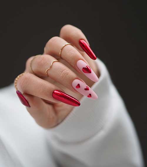 Long almond-shaped red Chrome nails with two accent matte nude pink nails adorned with red chrome hearts