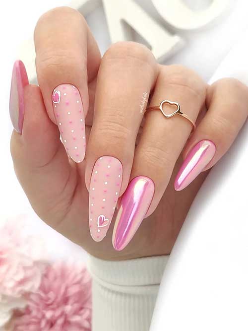 Long pearl pink Valentine's Day nails with two matte nude accent nails adorned with white and pink polka dot nail art Long pearl pink Valentine's Day nails with two matte nude accent nails adorned with white and pink polka dot nail art