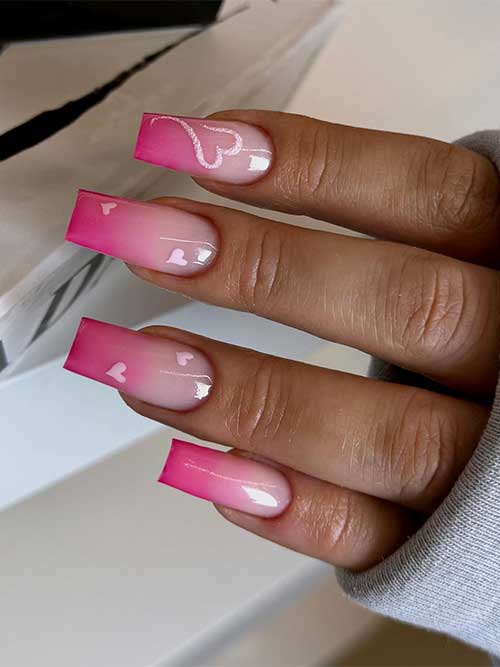 Simple pink ombre nails feature nude pink to hot pink nail colors and are adorned with pastel pink heart shapes