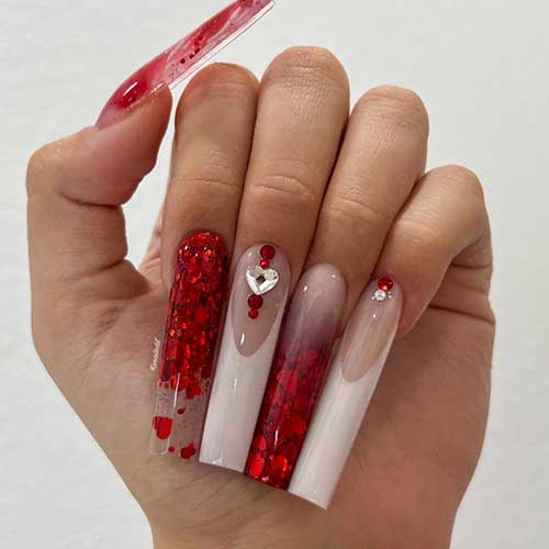 Sparkling red and white Valentine’s Day nail design with two clear accent nails with encapsulated red glitter heart shapes