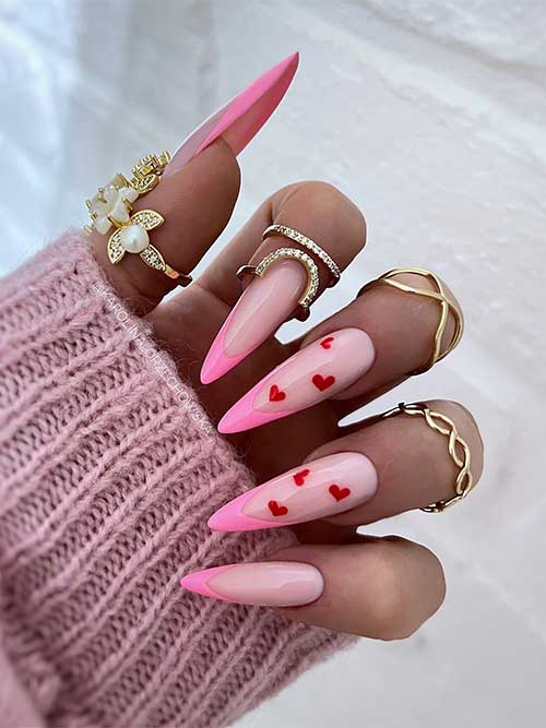 Stiletto classic French light pink Valentine's Day nails with small red hearts on two accent nails Stiletto classic French light pink Valentine's Day nails with small red hearts on two accent nails