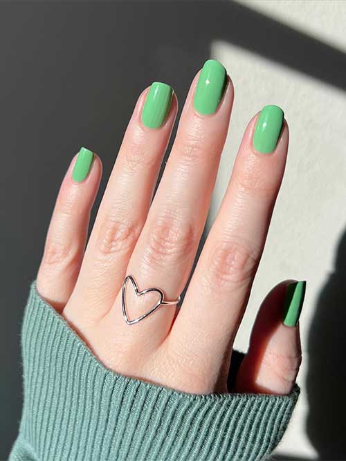 Short bright minty green nails using Essie Perfectly Peculiar nail polish from Essie Odd Squad Collection