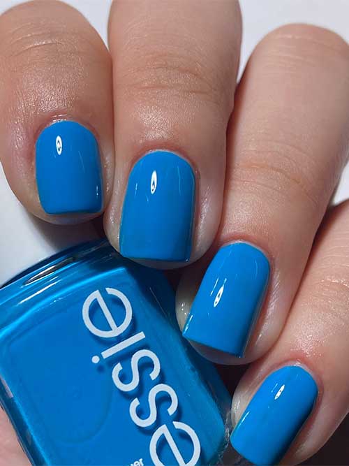 Short cyan-blue nails using Essie Offbeat Chic nail polish from Essie Odd Squad Collection