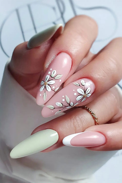 Long almond-shaped pastel green spring nail design features two pastel green nails and two accent floral nails