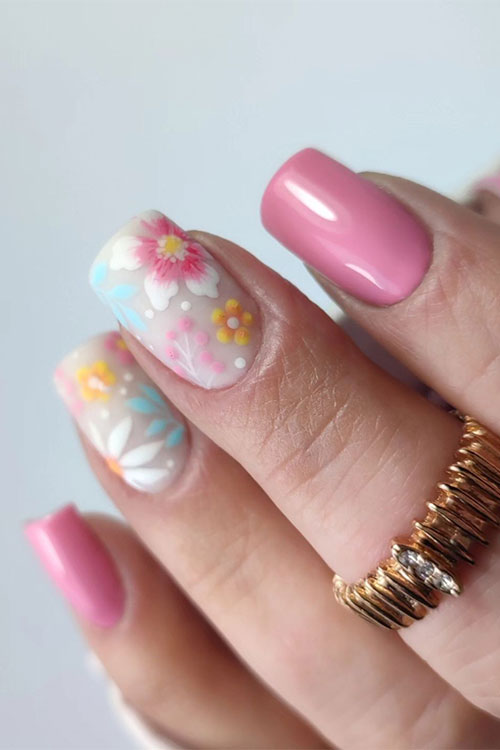 Pastel pink nails with colorful pastel flowers on two accents are one of the cutest spring nail ideas with flowers