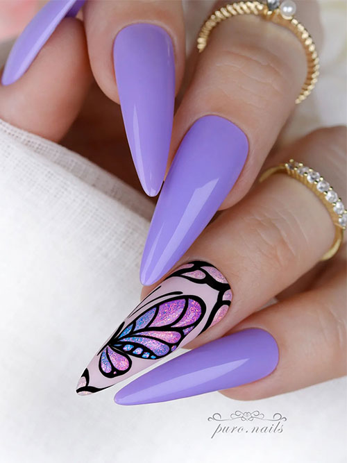 Light purple nails long almond shaped with a nude accent adorned with sparkling ombre purple pink butterfly fairy wings art