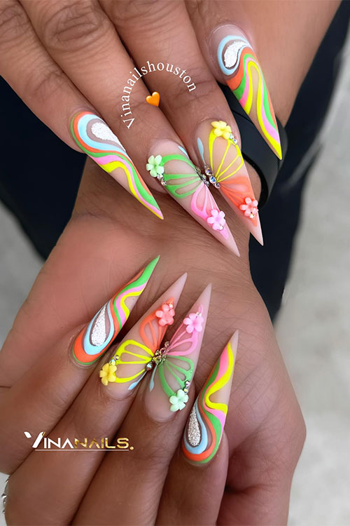 Matte long nails adorned with multicolored swirls and a multicolored butterfly nail art over the middle and ring fingernails