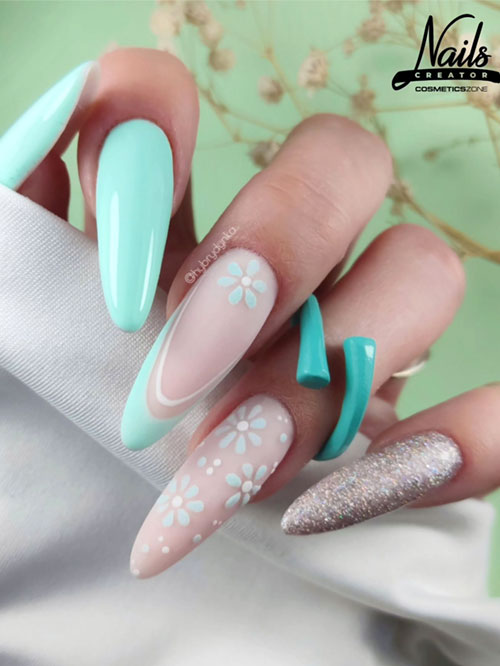 Green spring nails have almond-shaped features, pastel green and nude colors, delicate floral details, and a glitter accent. Green spring nails have almond-shaped features, pastel green and nude colors, delicate floral details, and a glitter accent.