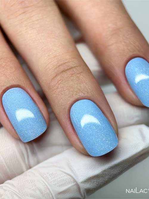 Elegant light blue nails with a soft shimmer, reminiscent of a clear sky, offering a tranquil and sophisticated look. Elegant light blue nails with a soft shimmer, reminiscent of a clear sky, offering a tranquil and sophisticated look.