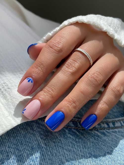 Enchanting blue nails with pink accents are adorned with delicate floral accents for a chic, modern look. Enchanting blue nails with pink accents are adorned with delicate floral accents for a chic, modern look.