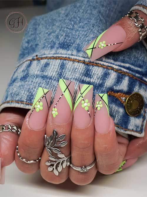 Green spring nail design with a nude base, featuring geometric patterns, floral details, and sleek black lines on long nails Green spring nail design with a nude base, featuring geometric patterns, floral details, and sleek black lines on long nails
