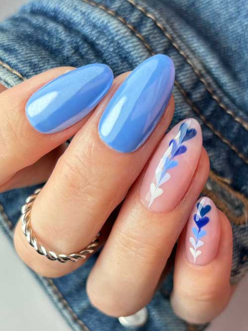 Light blue nails with whimsical white and blue hearts create a romantic and sophisticated nail art design. Light blue nails with whimsical white and blue hearts create a romantic and sophisticated nail art design.