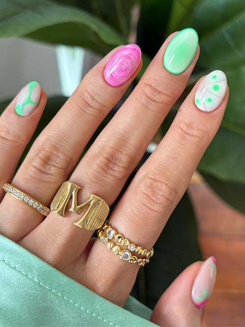 Playful green spring nails with pastel hues, abstract shapes, and gold rings for a fresh seasonal look. Playful green spring nails with pastel hues, abstract shapes, and gold rings for a fresh seasonal look.