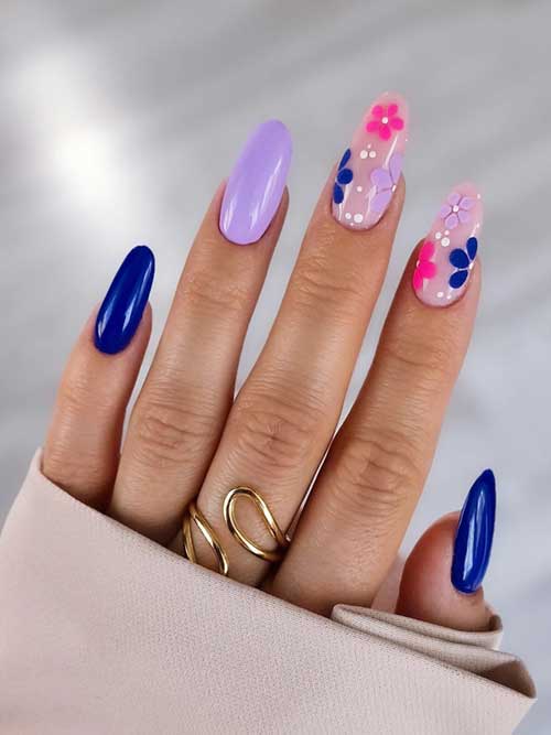 Stunning nail art showcasing a blend of blue and lavender shades, embellished with whimsical 3D floral details on pink. Stunning nail art showcasing a blend of blue and lavender shades, embellished with whimsical 3D floral details on pink.