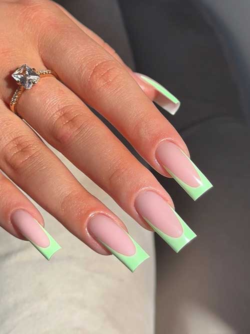Stylish French green spring nails with soft pink base and vibrant green tips on long, square-shaped nails. Stylish French green spring nails with soft pink base and vibrant green tips on long, square-shaped nails.