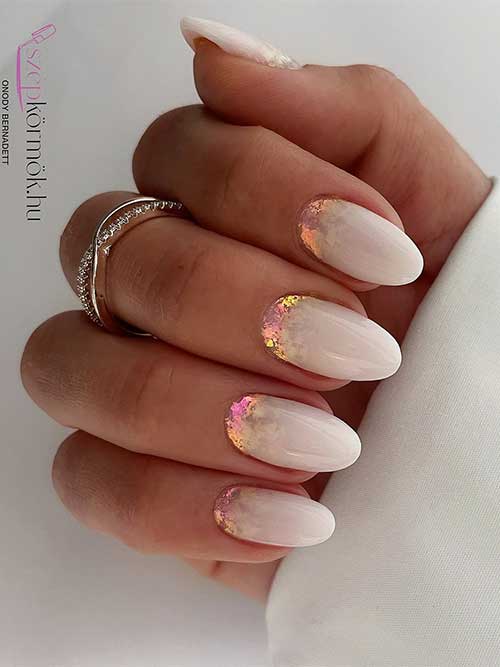 Elegant white nails with iridescent shimmer and stardust flakes, evoking a celestial charm and soft, ethereal beauty. Elegant white nails with iridescent shimmer and stardust flakes, evoking a celestial charm and soft, ethereal beauty.