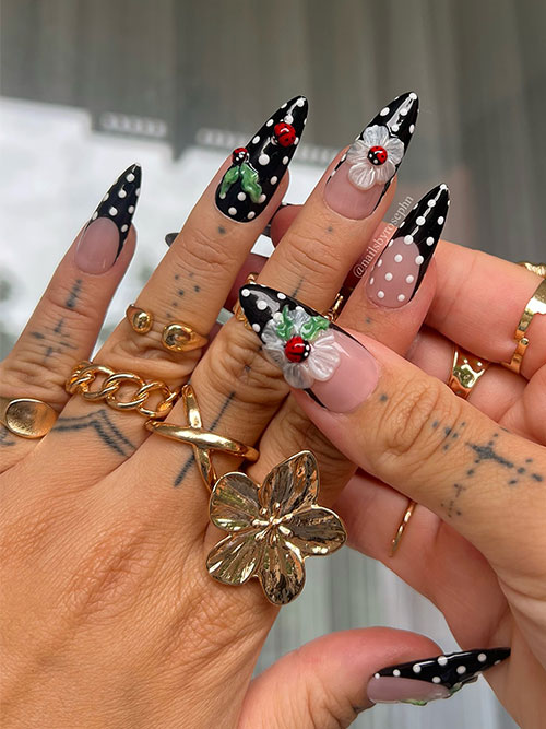 Chic stiletto black polka dot summer nails with white polka dots, adorned with 3D flowers and ladybugs. Chic stiletto black polka dot summer nails with white polka dots, adorned with 3D flowers and ladybugs.