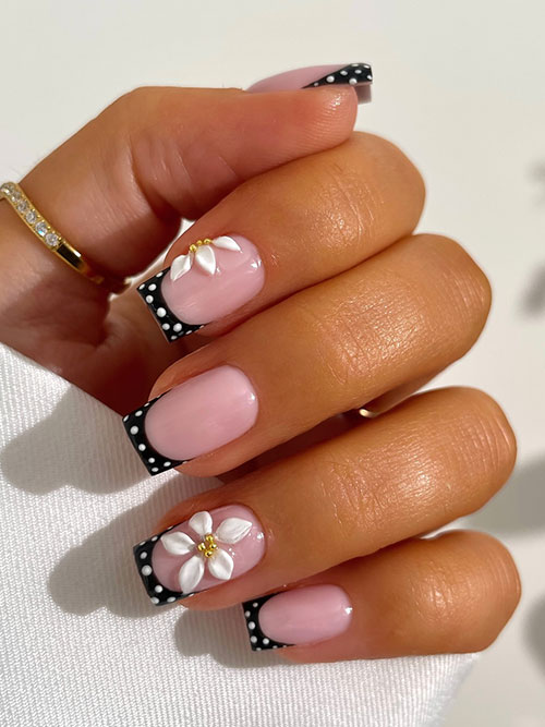 short black French polka dot summer nails with white dots, adorned with 3D white flowers and gold centers for a chic look. short black French polka dot summer nails with white dots, adorned with 3D white flowers and gold centers for a chic look.